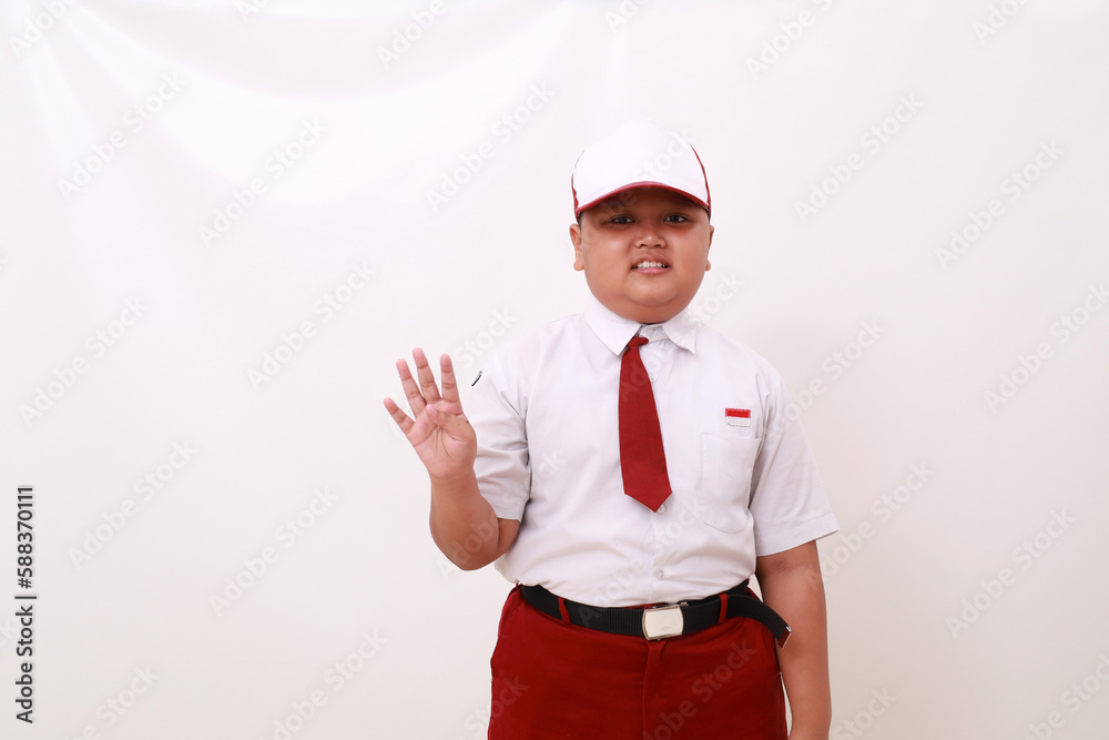 Elementary school student wearing red white uniform and showing four fingers. Isolated on white Elementary school student wearing red white uniform and showing four fingers. Isolated on white
