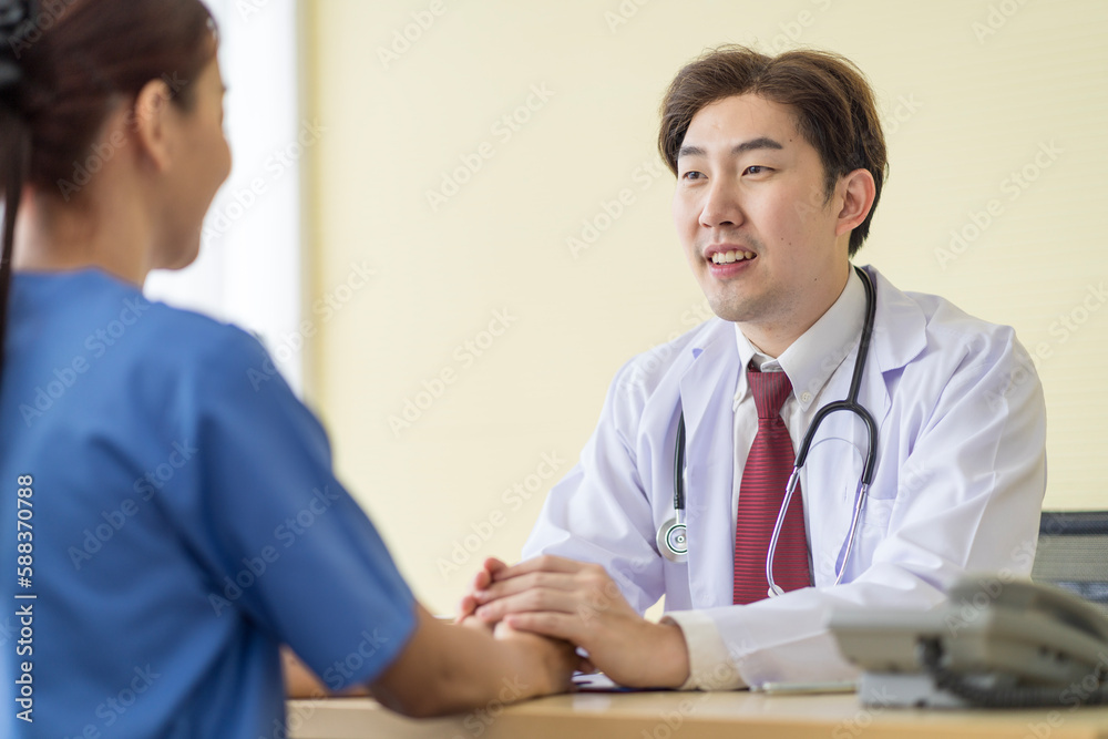 Asian doctor talking to patient with smile to encourage patients at the hospital Asian doctor talking to patient with smile to encourage patients at the hospital
