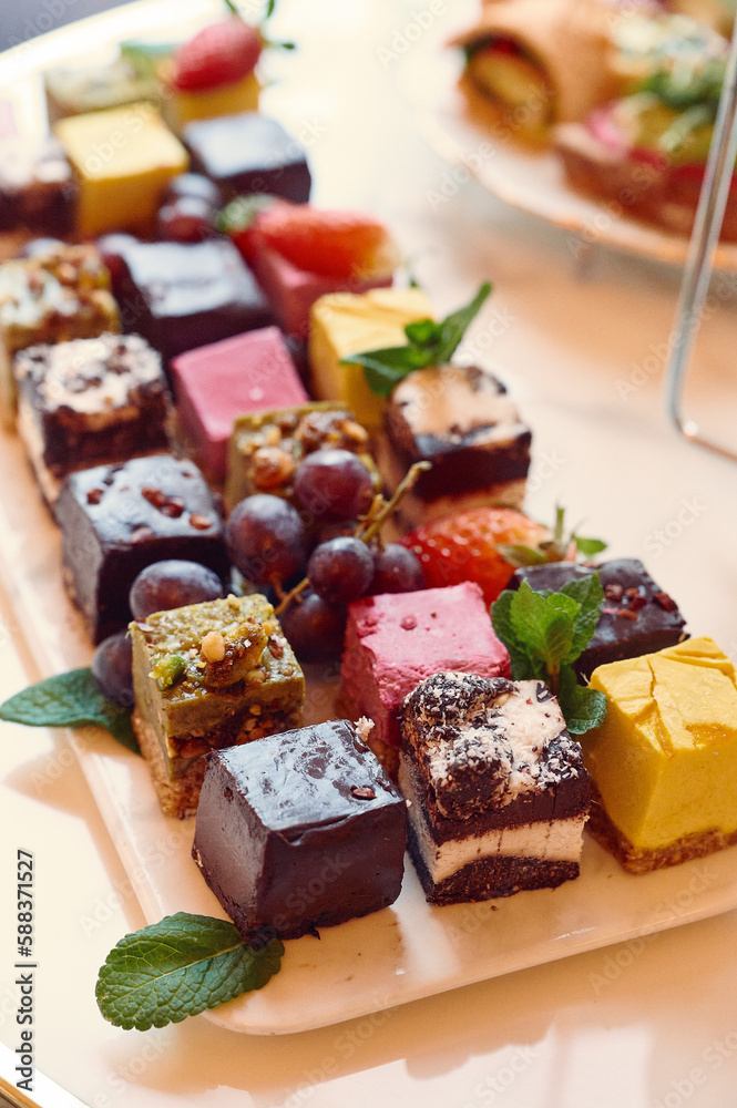 a white plate topped with assorted desserts on top of a table