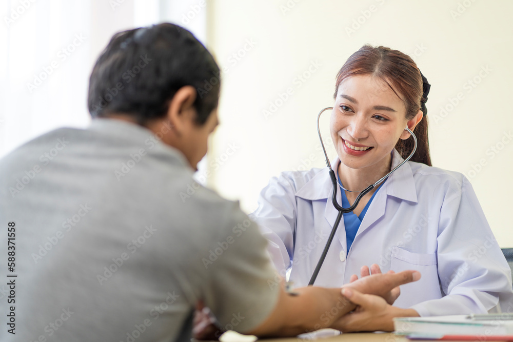 Asian doctor talking to patient with smile to encourage patients at the hospital Asian doctor talking to patient with smile to encourage patients at the hospital