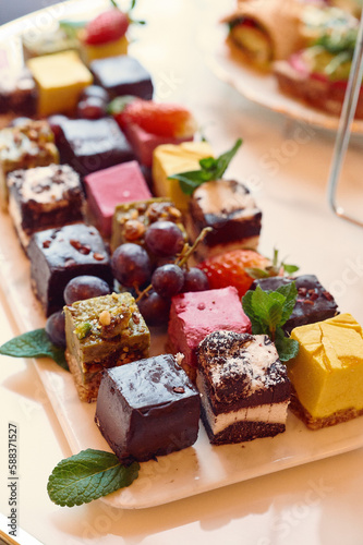 a white plate topped with assorted desserts on top of a table