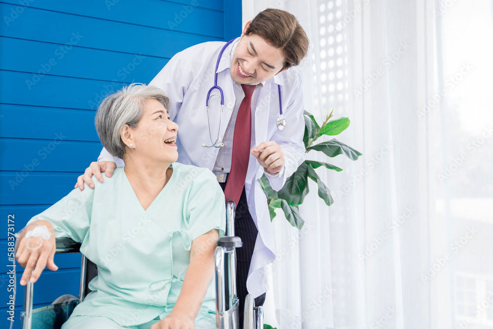A doctor is caring for an elderly female patient at a hospital where she has undergone knee surgery. This made her need to use a wheelchair instead of walking and have a doctor take care of it closely A doctor is caring for an elderly female patient at a hospital where she has undergone knee surgery. This made her need to use a wheelchair instead of walking and have a doctor take care of it closely