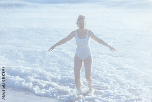 smiling elegant woman in beachwear at beach having fun time