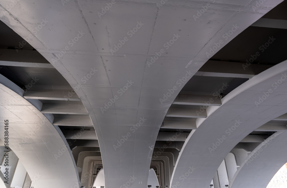 Fototapeta premium View of the arches of the concrete bridge from below.