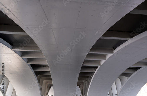 View of the arches of the concrete bridge from below.