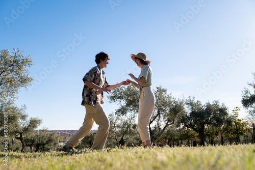couple of lgbt women dancing in nature outside with sunset light