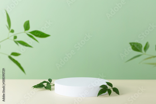Abstract empty white podium with palm leaves on beige background