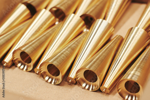 Photography a bunch of brass pipes lined up on a table