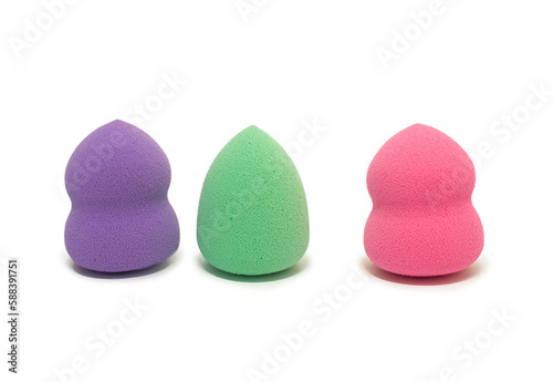 Colored makeup sponges purple, pink, green on a white background. Means for applying professional make-up