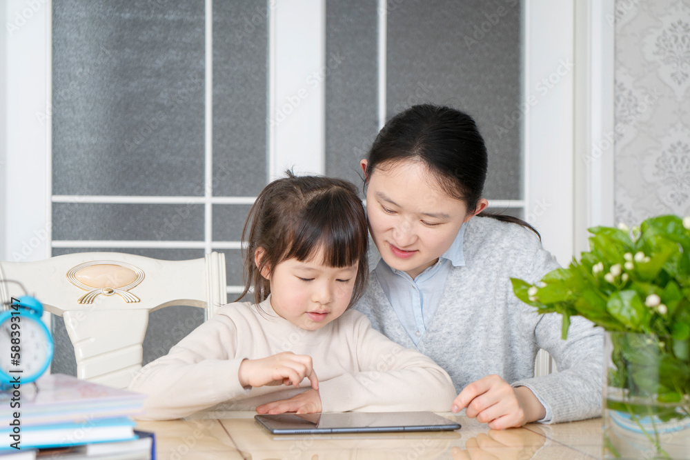 Mom and daughter learn online classes together