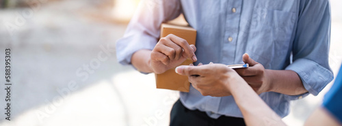 Schilderij op canvas customer signature in mobile phone, man receiving parcel box from courier with d