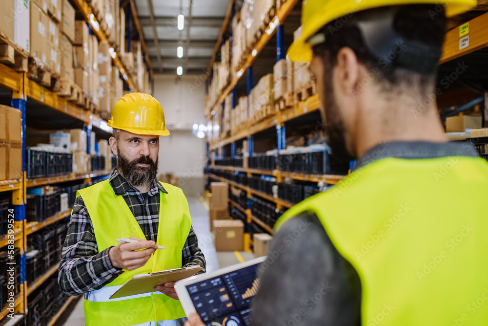 Warehouse workers checking stuff in warehouse with digital system in tablet. Warehouse workers checking stuff in warehouse with digital system in tablet.