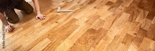 Craftsman laying oak parquet with a click system, panorama