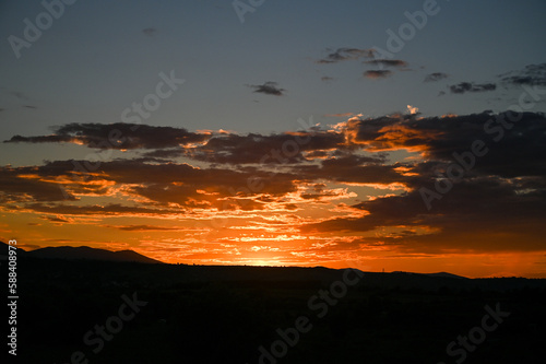 Sunset. The sun went down behind the mountain. Orange sunset.