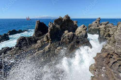 Ocean wave among volcanogenic rocks of cape Barbero, Tenerife, Canary. photo