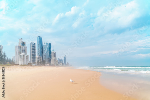Beautiful panoramic view of the Gold Coast skyline and Surfers Paradise beach with rolling waves of Pacific ocean on a beautiful cloudy day. © SeaRain