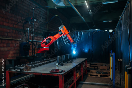 Automated robotic welder operating.