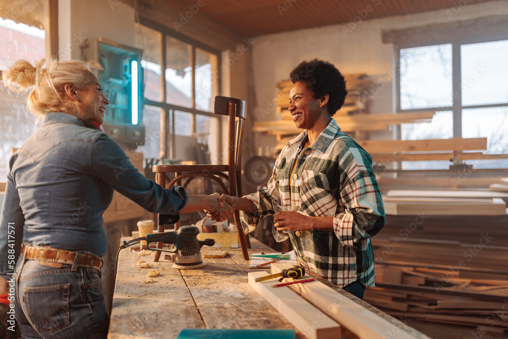 Diverse carpenters shaking hands. Diverse carpenters shaking hands.
