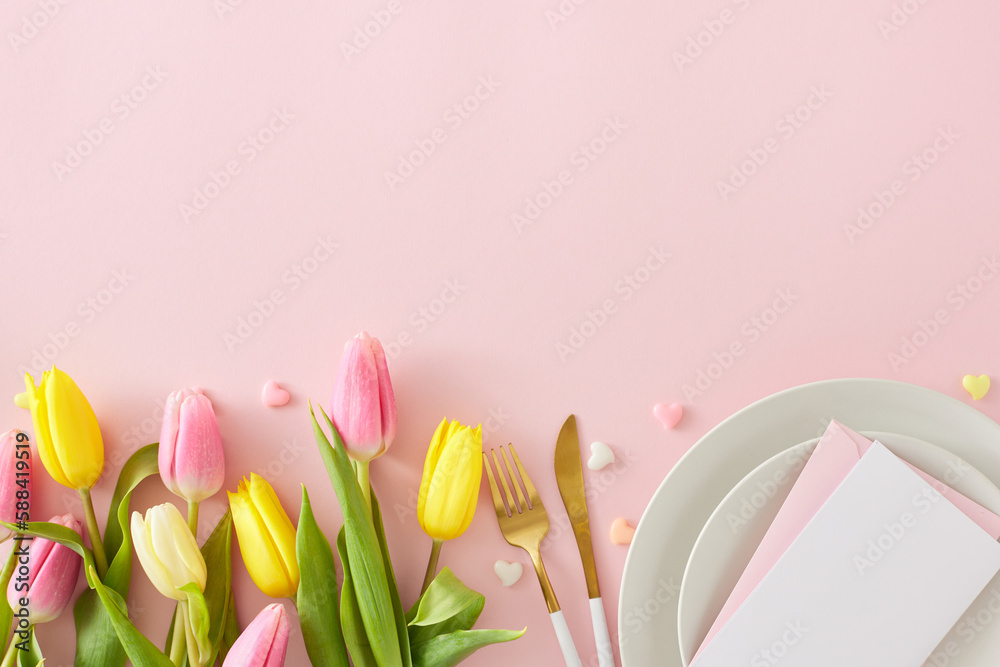 Happy Mother's Day concept. Flat lay photo of circle plate cutlery knife fork postcard yellow pink tulips and hearts baubles on isolated pastel pink background with empty space