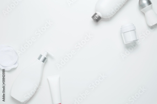 Cosmetic beauty products on white background. Bottles and tubes with branding mock up. Skin care and beauty concept. Top view, flat lay, copy space