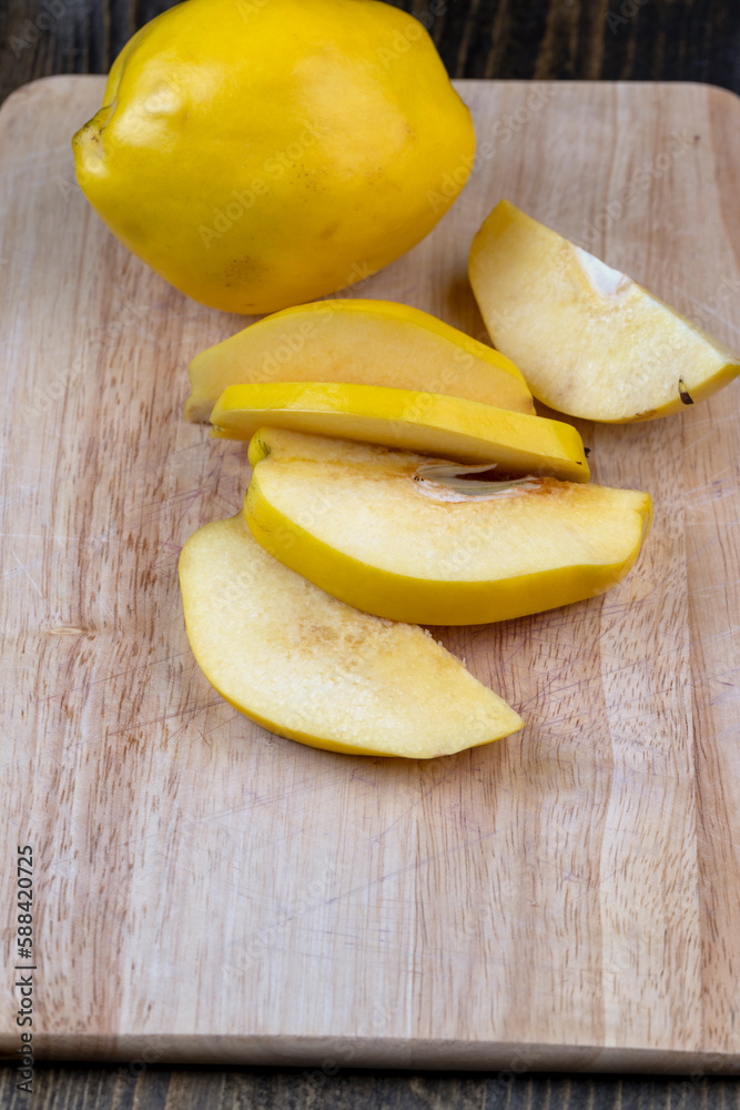 Sliced ripe yellow quince on a cutting board