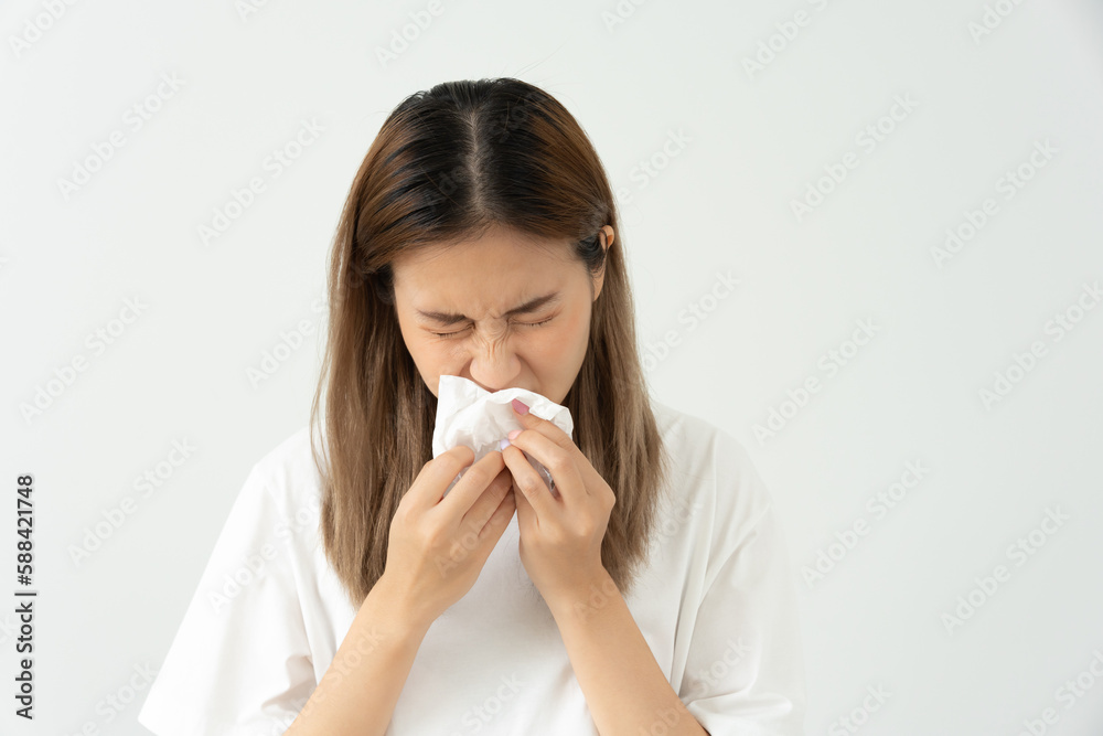 Pollen Allergies, asian young woman sneezing in a handkerchief or blowing in a wipe, allergic to wild spring flowers or blossoms during spring. allergic reaction, respiratory system problems. Pollen Allergies, asian young woman sneezing in a handkerchief or blowing in a wipe, allergic to wild spring flowers or blossoms during spring. allergic reaction, respiratory system problems.
