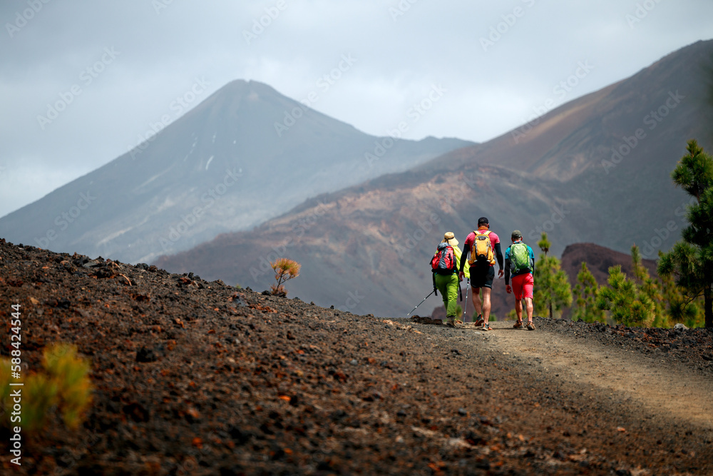  Group of friends hiking in Tenerife with a volcano in the background. Scenic hike landscape