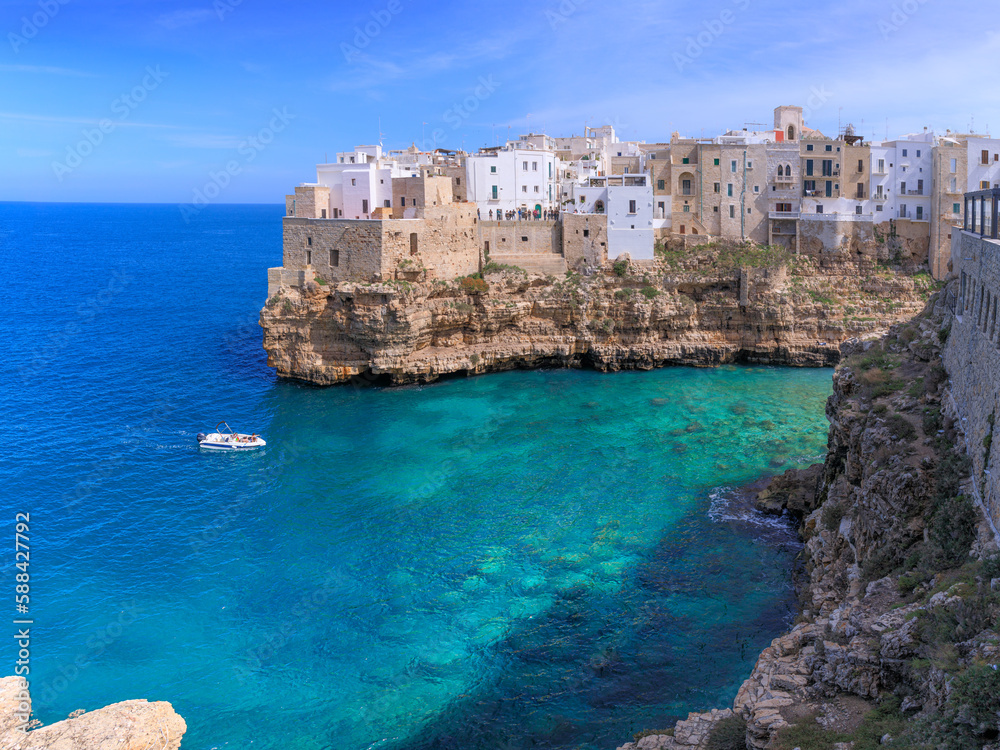 Polignano a Mare: Cala Monachile Beach in Italy (Apulia). It is located in the center of Polignano, a few steps away from the historic center. Polignano a Mare: Cala Monachile Beach in Italy (Apulia). It is located in the center of Polignano, a few steps away from the historic center.