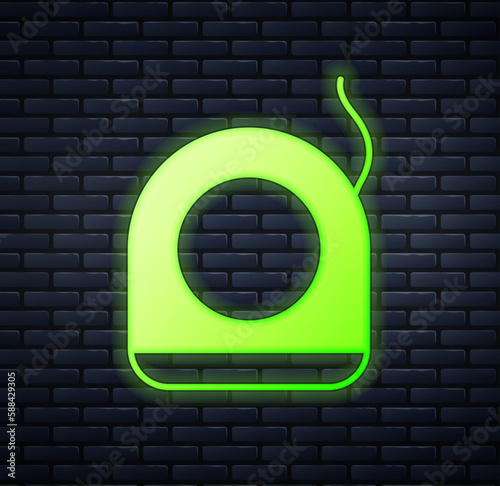 Glowing neon Dental floss icon isolated on brick wall background. Vector