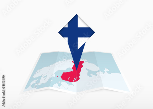 Finland is depicted on a folded paper map and pinned location marker with flag of Finland.