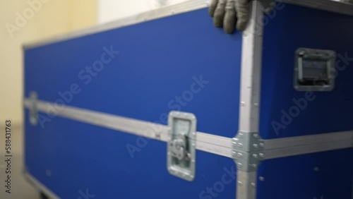 Roadie, Stage Crew pushing a Flightcase on a stage. The Stage Worker at concert