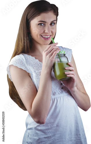 Portrait of woman sipping on green juice