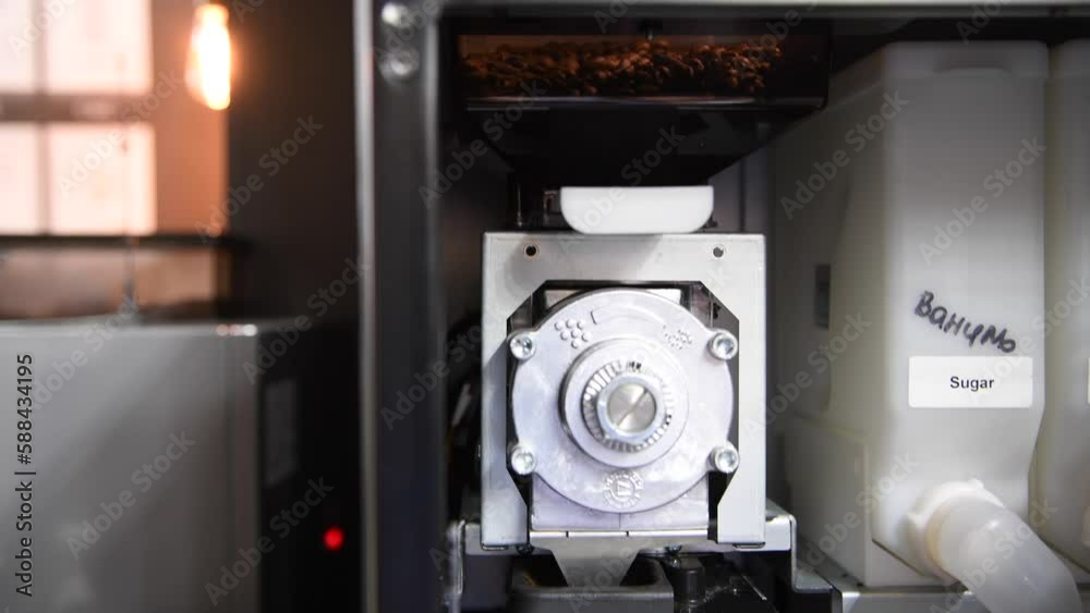 Inside view of open beantocup vending coffee machine with grinder