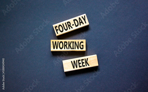 Four-day working week symbol. Concept words Four-day working week on wooden block on a beautiful black table black background. Business four-day working week concept. Copy space.