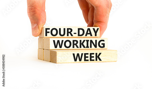 Four-day working week symbol. Concept words Four-day working week on wooden block on a beautiful white table white background. Businessman hand. Business four-day working week concept. Copy space.