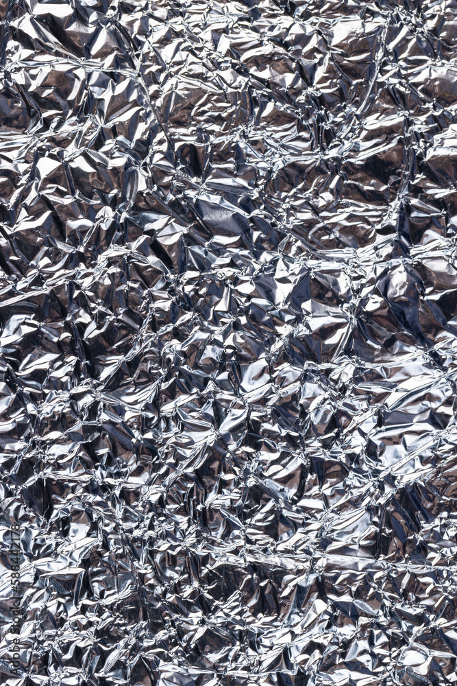 crumpled thin aluminum foil reflecting light