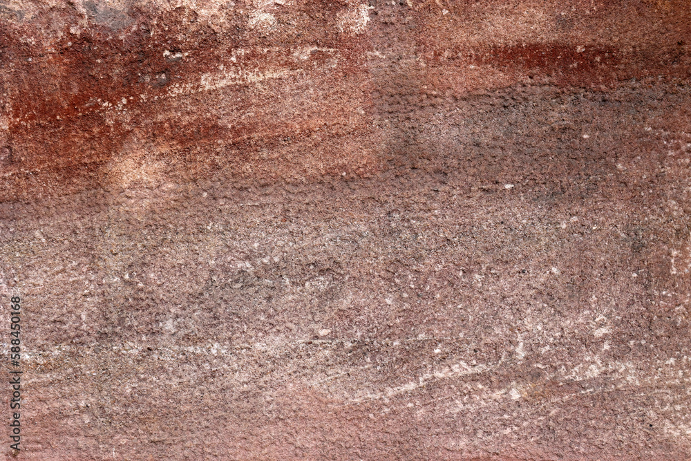 Closeup of red stone with quarry cutting marks as a background texture Closeup of red stone with quarry cutting marks as a background texture