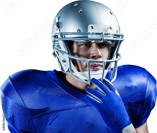 Confident sportsman holding helmet while looking away