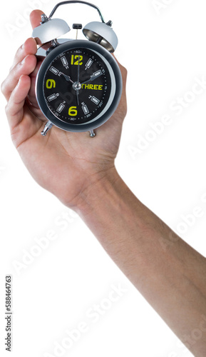 Cropped hand of man holding alarm clock