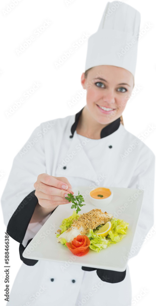 Female chef seasoning meal with parsley Female chef seasoning meal with parsley