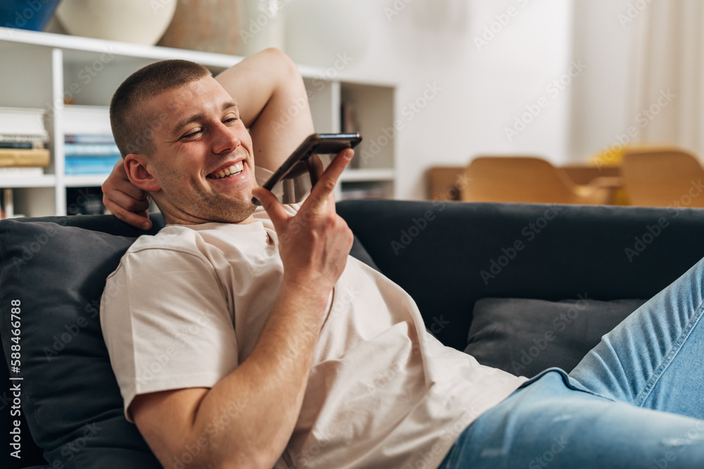 A happy Caucasian man is speaking over the phone