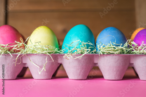 Front View of Colorful Vibrant Easter Eggs on a Wooden Background
