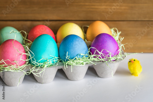 Vibrant colorful easter eggs in a basket