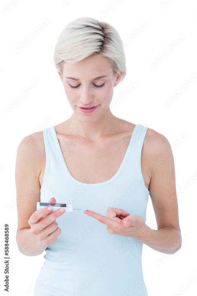 Pretty blonde testing her blood glucose level Pretty blonde testing her blood glucose level