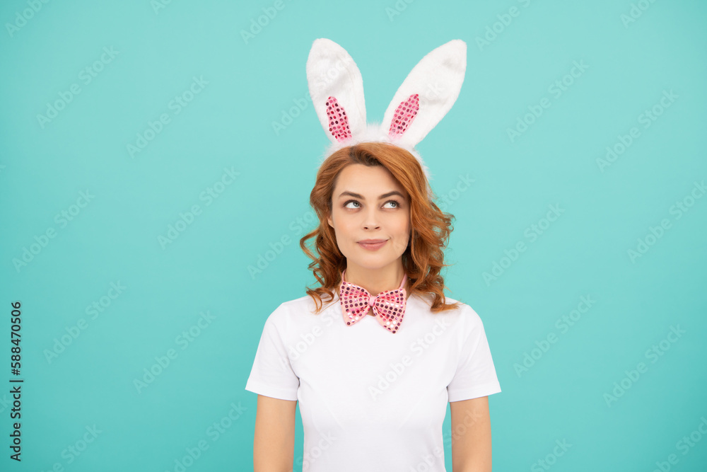 dreaming easter woman with bunny ears on blue background