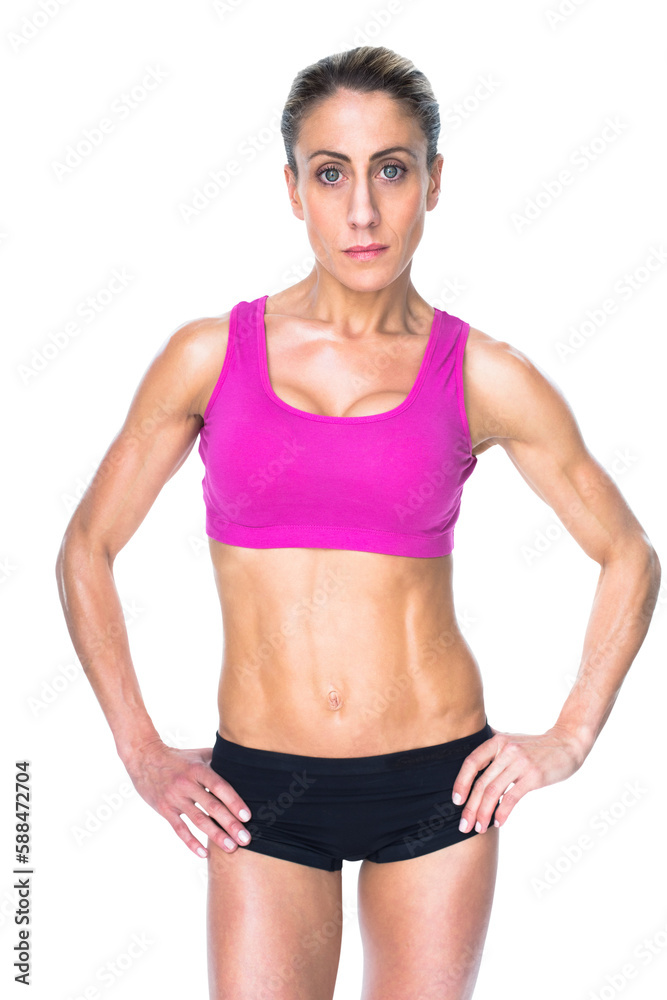 Female bodybuilder posing with hands on hips looking at camera Female bodybuilder posing with hands on hips looking at camera