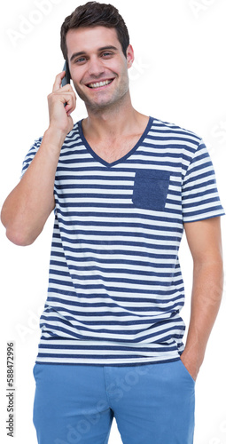 Handsome man smiling while talking on mobile phone