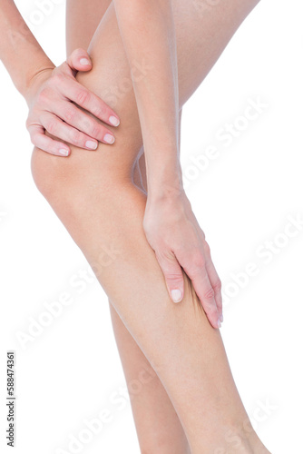 Attractive woman touching her leg 