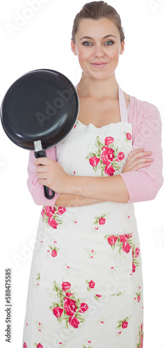 Young woman with arms crossed holding frying pan