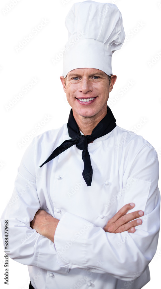 Happy male chef standing with arms crossed in kitchen